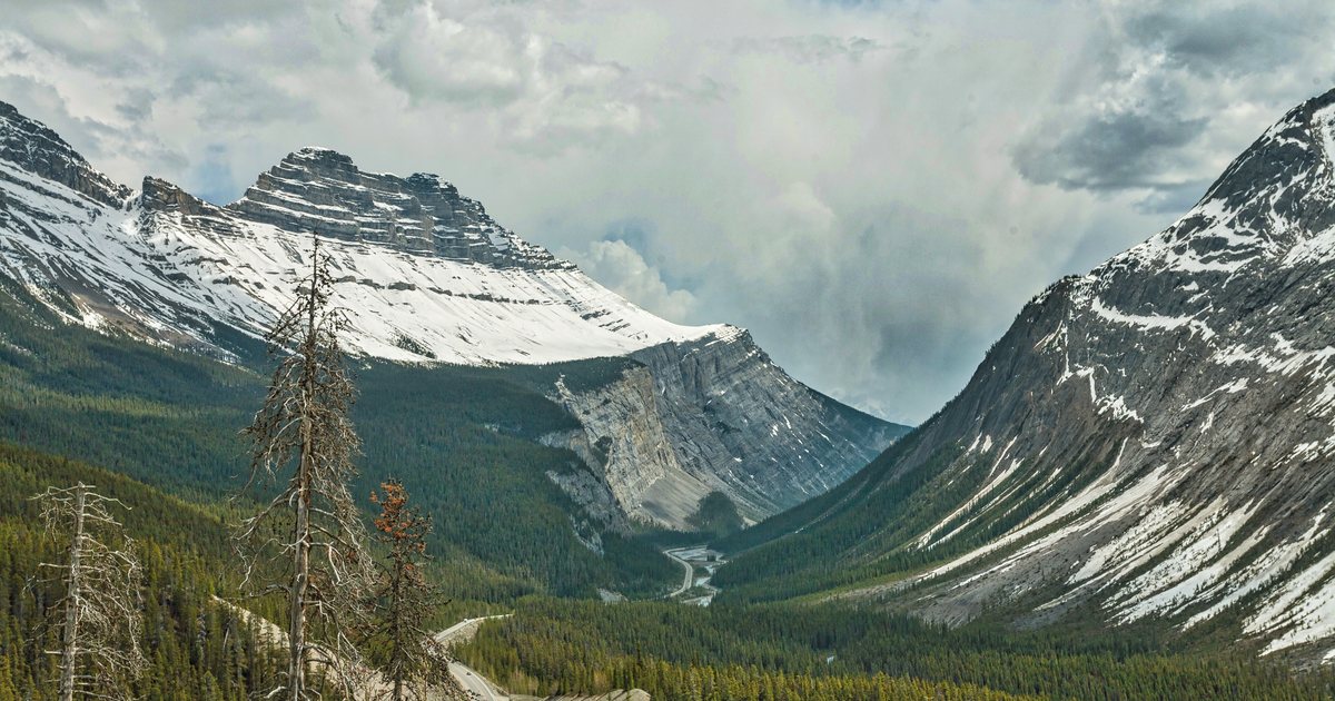 The Canadian Rocky Mountains beneath a cloudy sky
