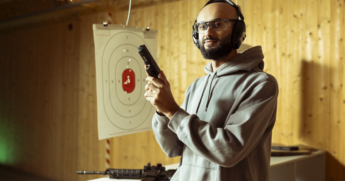 A man reviewing training equipment at an indoor range