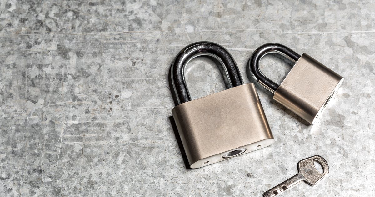 Two metal padlocks and a key