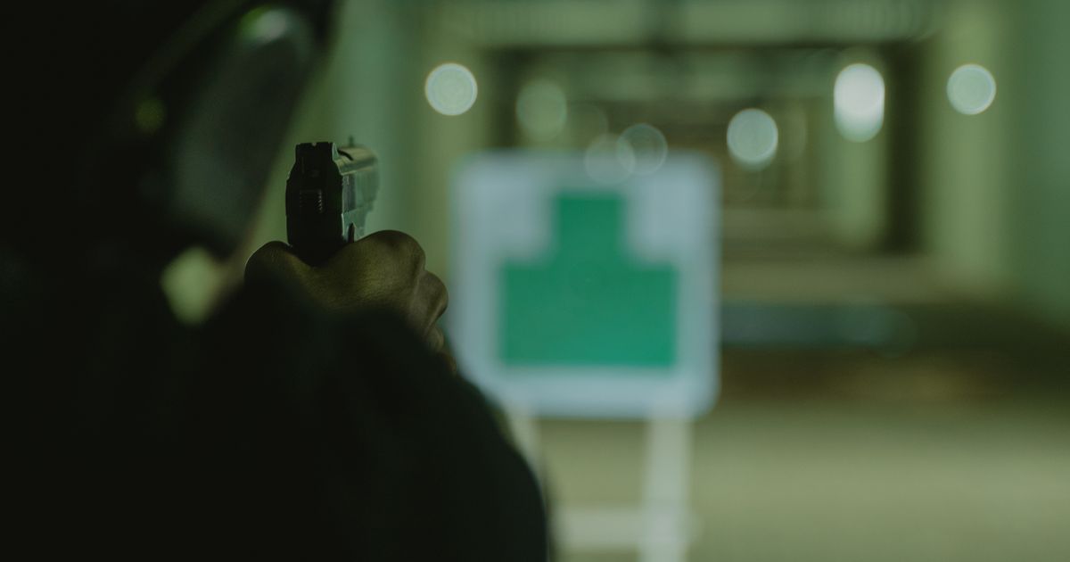 A man at an indoor shooting range